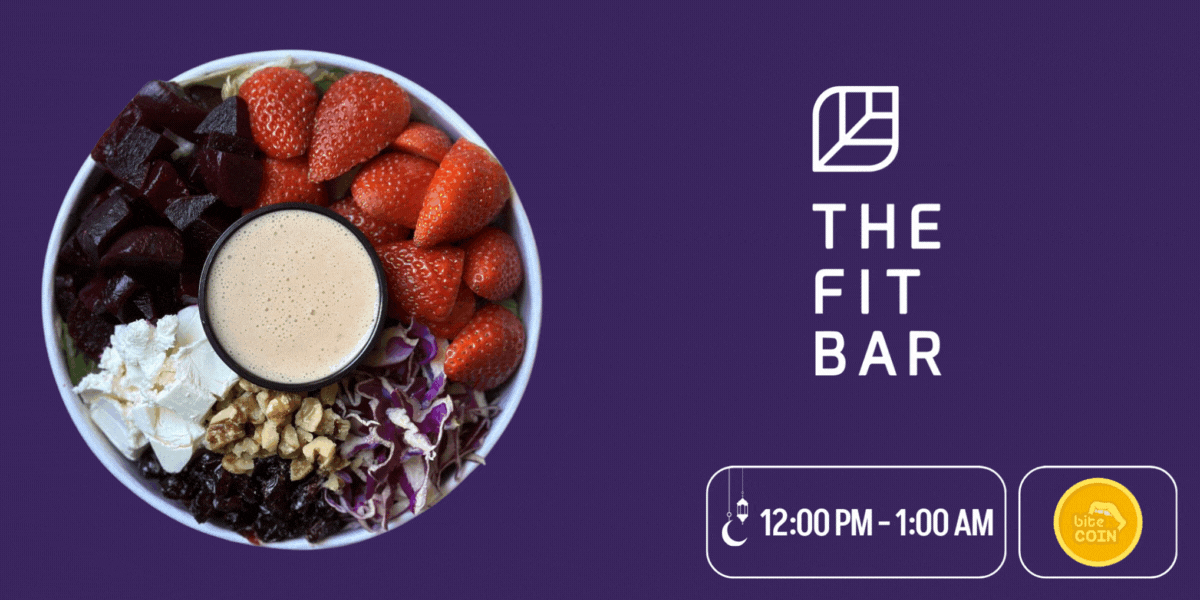 A healthy salad with strawberries, feta cheese, dates and a sauce in the middle from The Fit Bar with the biteCOIN icon in the bottom right