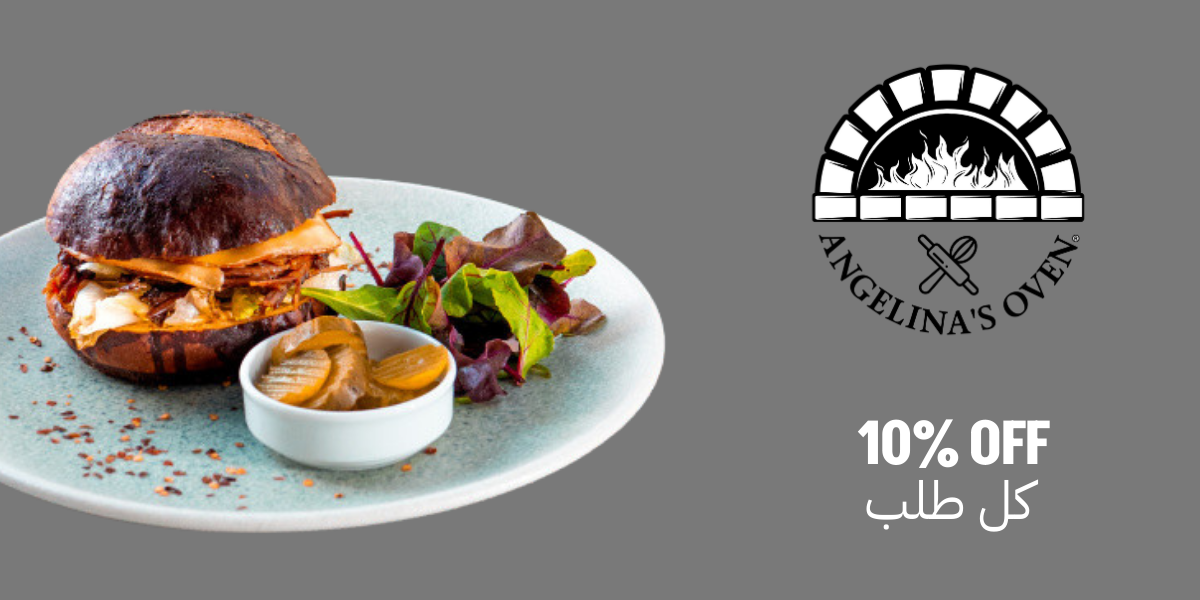 Brisket sandwich on a plate with a salad and pickles from Angelina's Oven with the 10% off icon